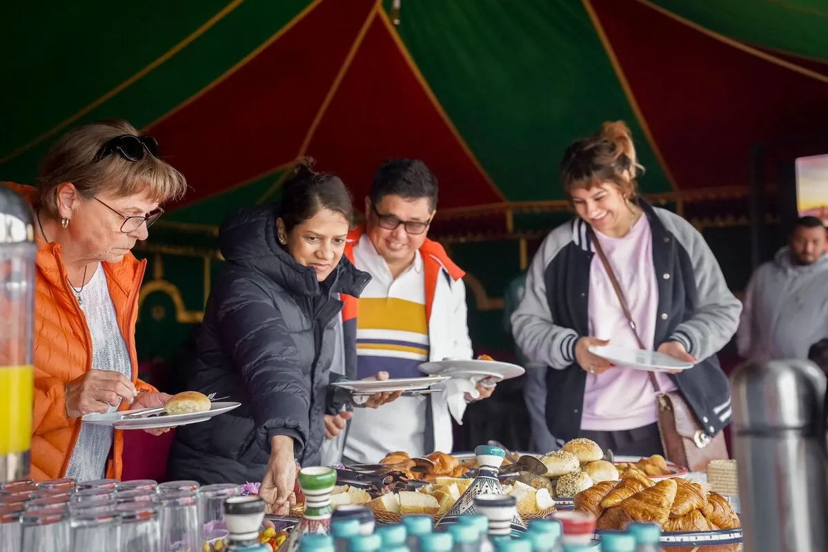 Guests enjoying traditional Moroccan breakfast buffet in tent